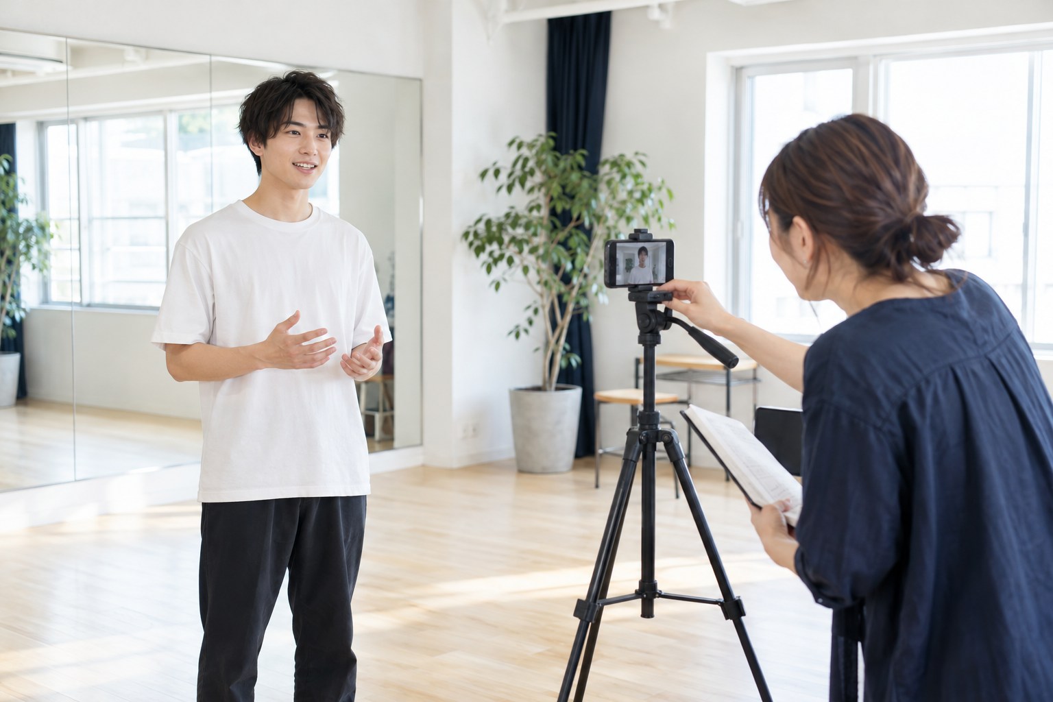本人紹介の動画に向け、撮影位置を確認する出演者と担当者